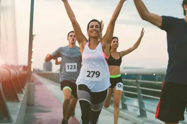 woman running happy arms up with no concern of stress incontinence Plymouth