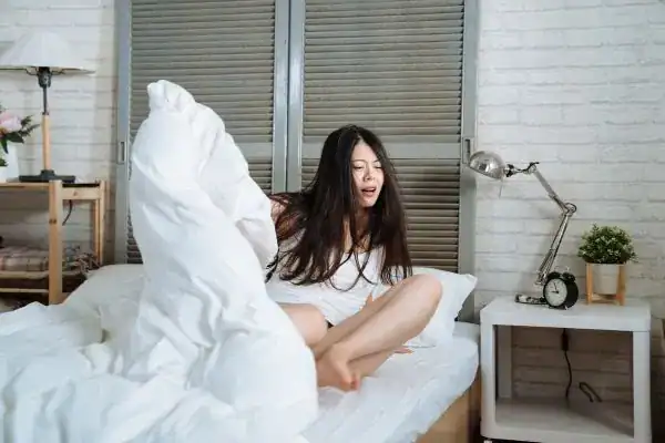 Image of woman getting up because of nighttime leaks Plymouth